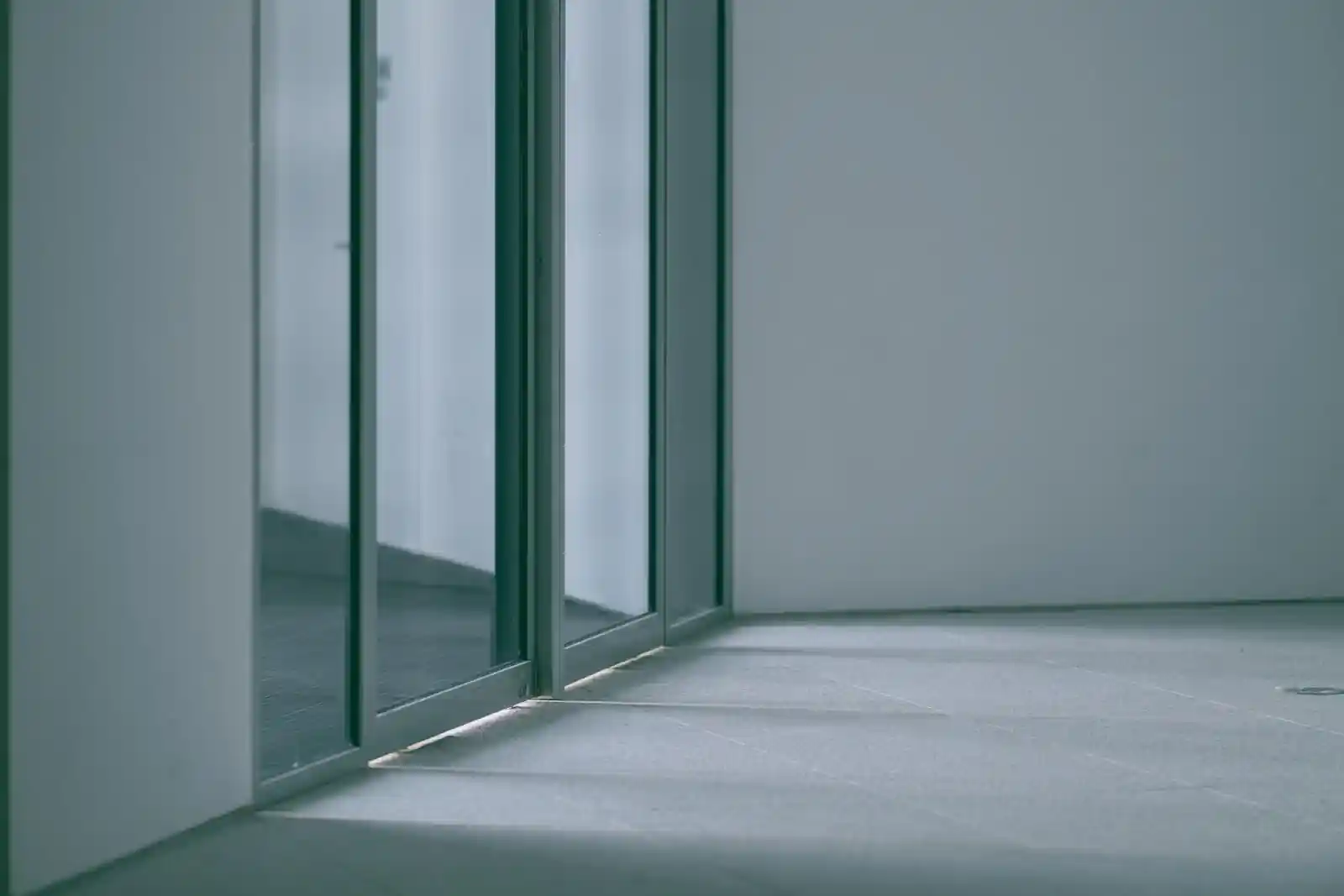 Empty room with floor-to-ceiling sliding glass doors