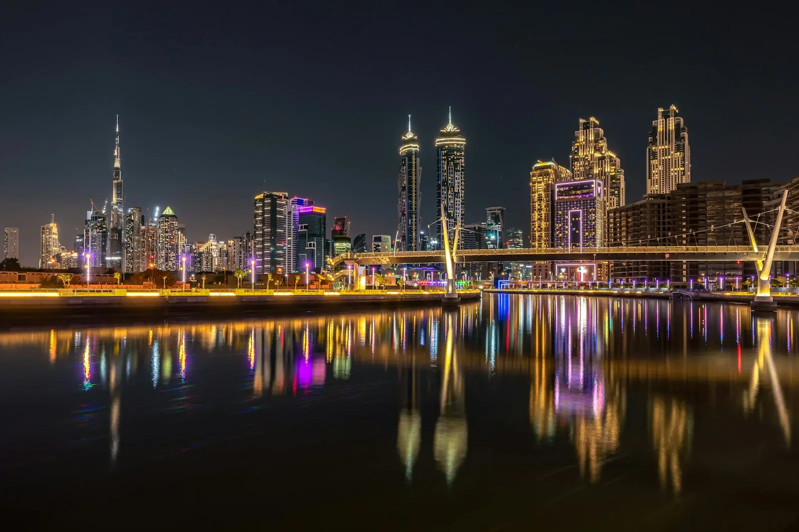 Dubai skyline reflected in water at night