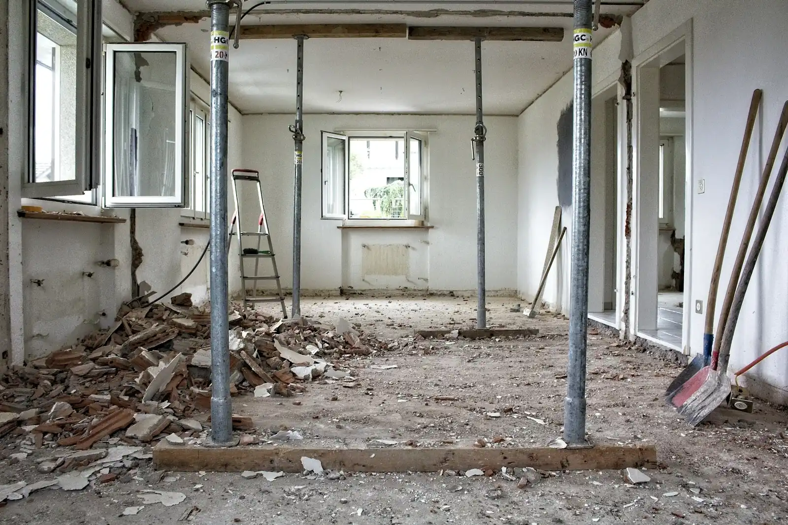 Room stripped back during renovation, with debris and support props